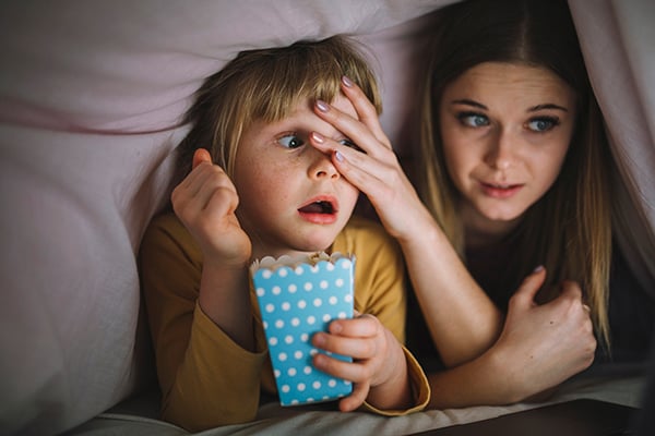 Scared kids watching a scary movie so they're scared. 